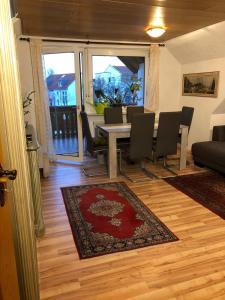 a living room with a dining room table and chairs at Ferienwohnung Bodensee LA in Langenargen
