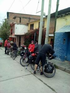 a group of people riding bikes down a street at Monkeywasi Climbing Hostel in Huaraz