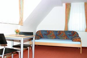 a couch in a room with a table at Das Apartmenthaus in Stuttgart