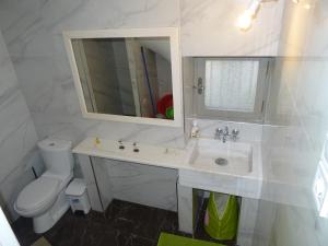 a white bathroom with a sink and a toilet at FOTIS HOUSE in Koroni +24 photos