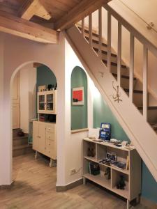an attic room with a staircase and a desk underneath it at B&B Mastro Francesco in Scilla