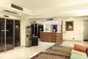 a large room with a lobby with a reception at Augustus Hotel in Biella
