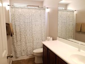 a bathroom with a toilet and a shower curtain at Phoenix I, Minutes to Airport and Downtown in Phoenix