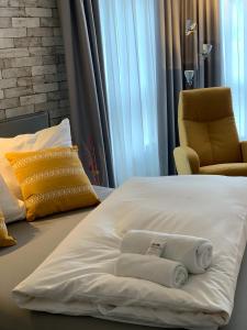 a hotel room with a bed with towels on it at Residenz Hotel Giessen in Gießen