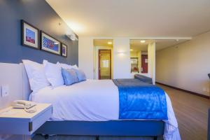 a bedroom with a large bed and a table at Comfort Suites Brasília in Brasilia