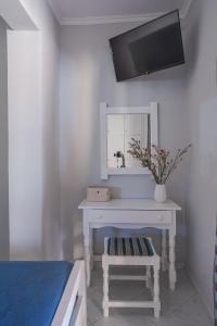a bedroom with a white dressing table and a mirror at Orange Apartments in Vasiliki