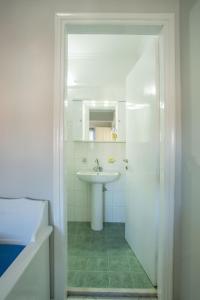a bathroom with a sink and a toilet and a mirror at Orange Apartments in Vasiliki +51 photos