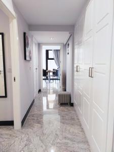 a hallway with white doors and a dining room at BOHEMIAN & SUITES PANORAMIC -parking in Seville