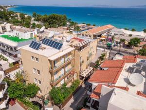 an aerial view of a city with buildings and the ocean at Filmar Hotel, Ixia, Rhodes in Ixia