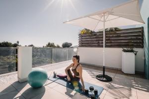 a woman doing a yoga pose on the floor of a house at Lux Isla in Talamanca