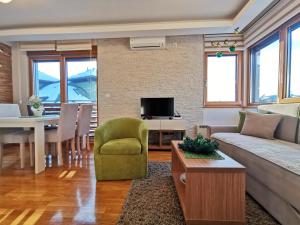 a living room with a couch and a table at Apartments Egoiste - Centar in Zlatibor