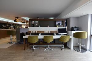 an office with a desk with chairs and a computer at Holiday Inn Wolverhampton - Racecourse by IHG in Wolverhampton