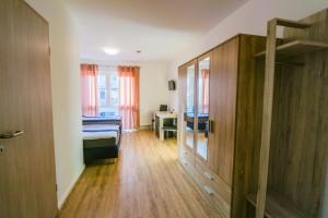 a bedroom with a bed and a desk in a room at Hotel sleep-station in Börnsen