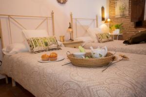 a bed with a basket of food on top of it at Casa Rural El Tenado in Aldea de Trujillo