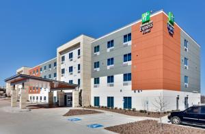 a hotel with a car parked in front of it at Holiday Inn Express & Suites Plano East - Richardson by IHG in Plano