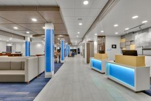 an office lobby with blue columns and desks at Holiday Inn Express & Suites Plano East - Richardson by IHG in Plano +20 photos