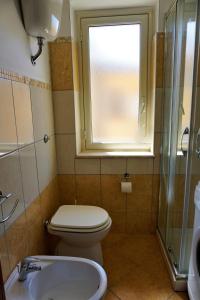 bagno con servizi igienici, lavandino e finestra di Central House a Realmonte
