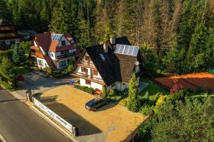 an aerial view of a house with a solar roof at Willa Czajka - Widokowe Apartamenty in Zakopane