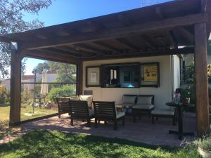 a patio with chairs and a table and a mirror at Residence Cort'e Accas in Bari Sardo