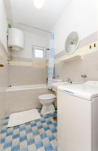 a bathroom with a sink and a toilet and a tub at Knezovicapartments in Živogošće +69 photos