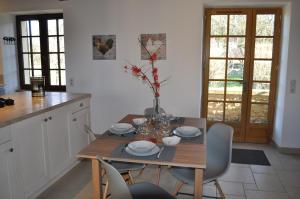 a kitchen with a wooden table with chairs and a dining room at Gîte pour 4 personnes - Dordogne in Bressac