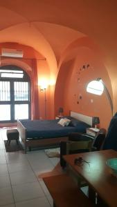 a bedroom with a bed in an orange room at La civita 1 in Catania