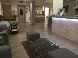 a lobby of a store with a table and chairs at Hotel Capitol in Pisa