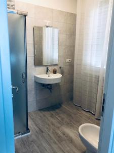 a bathroom with a sink and a mirror at Nannare' Rooms in Reggio Emilia