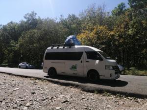 a white van is driving down a road at Agaseke Lodge Boquete in Boquete