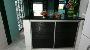 a black and white counter with vases and flowers on it at Hospedaria Casa Verde in Lençóis