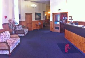 a living room filled with furniture and a tv at Leviathan Hotel in Dunedin