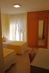 a hotel room with two beds and a window at Hotel Playa de Merón in San Vicente de la Barquera