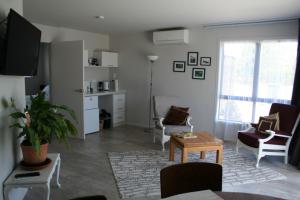 a living room with a couch and a table at AHAVA Bed & Breakfast in Waimate