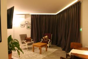 a living room with a couch and chairs and curtains at AHAVA Bed & Breakfast in Waimate