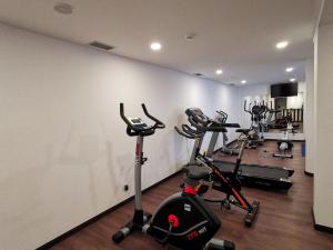 a gym with several exercise bikes in a room at Santa Cruz Village Hotel in Santa Cruz