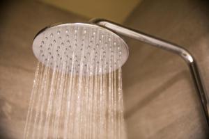 a shower head with water dripping from it at Nightcap at Manhattan Hotel in Ringwood