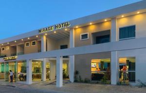 a large hotel with people standing outside of it at Mirage Hotel in Porto Seguro