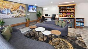 a living room with two couches and two tables at Best Western Atlanta-Marietta Ballpark Hotel in Atlanta