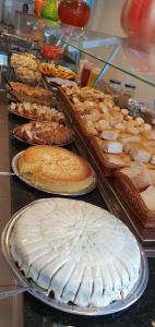 a display case with many different types of cakes and pies at Mirage Hotel in Porto Seguro