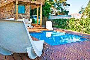 a swimming pool with a slide in a backyard at Funky Town in Jeffreys Bay