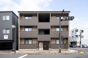 a building on a city street with a traffic light at Beans Stay Ishibiki in Kanazawa