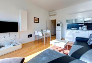 a living room with a couch and a kitchen at Villa Katarina 2nd Floor Apartments in Dubrovnik