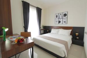 Łóżko lub łóżka w pokoju w obiekcie R Hotel Rancamaya