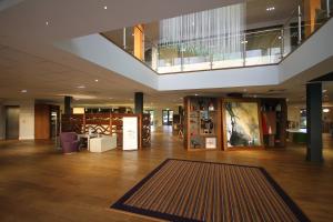 a lobby with a large rug in a building at Holiday Inn Huntingdon Racecourse, an IHG Hotel in Huntingdon