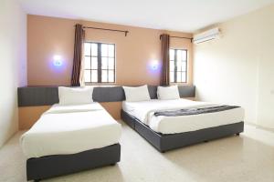 Postel nebo postele na pokoji v ubytování M S Hotel, Tengku Kelana KTM Klang