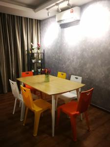 a dining room table with chairs and a table at Perfect Getaway @Vivacity in Kuching