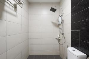 a white bathroom with a shower and a toilet at M S Hotel in Klang