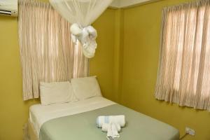 Säng eller sängar i ett rum på Aanola Villas A4 Spacious Caribbean Casa