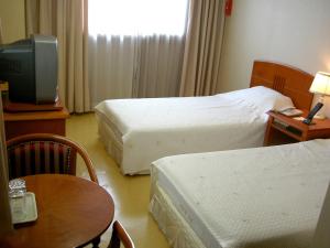 Postel nebo postele na pokoji v ubytování Busan Central Hotel