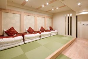 a large living room with couches in a room at Hotel Amaterrace Yosuga in Osaka